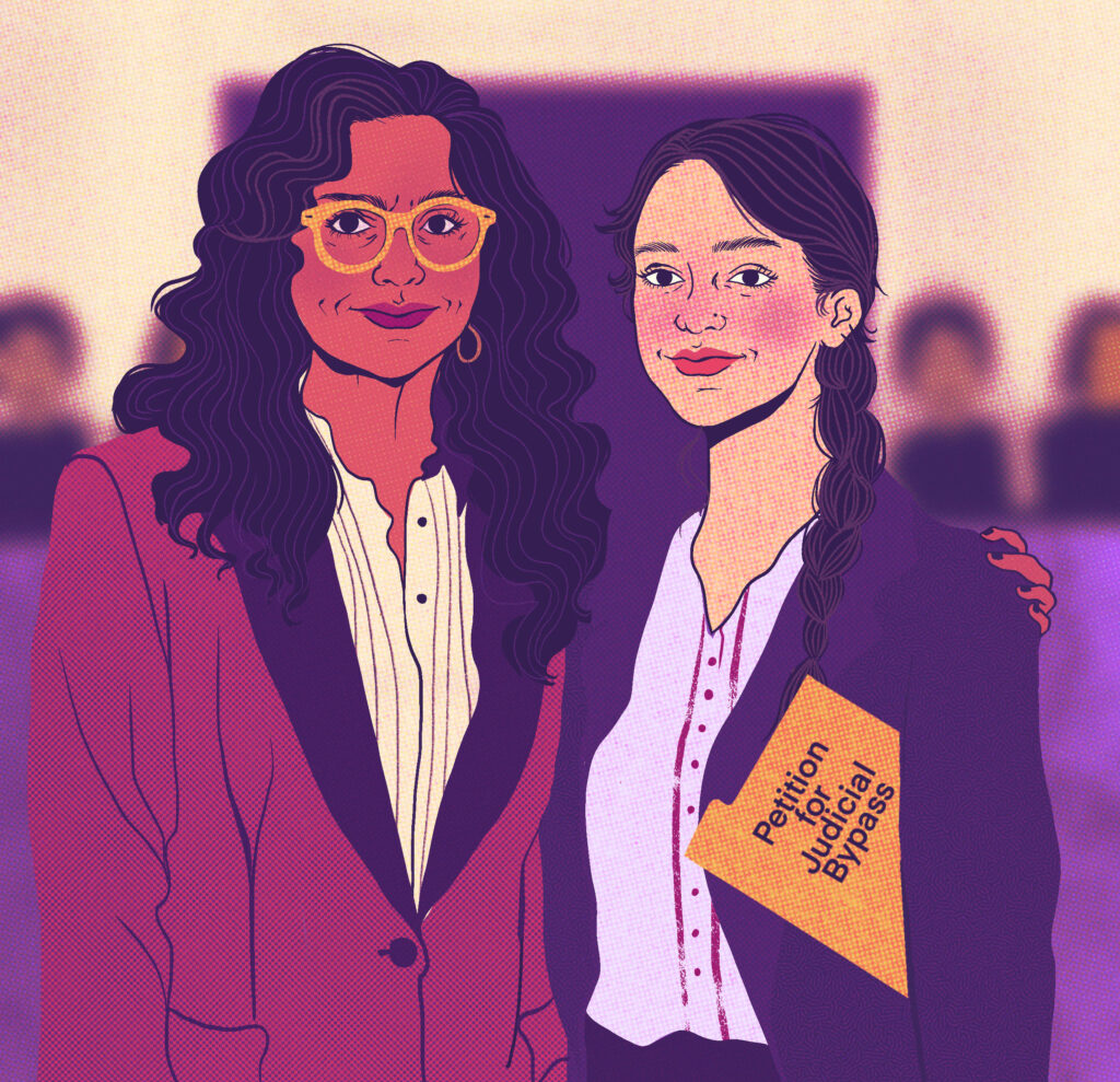 Two abortion access advocates stand next to each other in a courtroom. Both are wearing suit jackets. One person has their arm around the other. The second person  holds a folder that reads: Petition for judicial bypass. 
